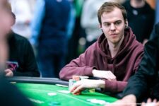 Ein Mann namens Michel Molenaar, der an einem Pokertisch sitzt und Karten hält, während er konzentriert in die Kamera schaut.
