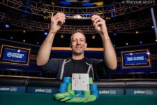 Ein Mann und eine Frau sitzen an einem Pokertisch, sie halten Karten in den Händen und schauen konzentriert auf den Tisch. Im Hintergrund sind Pokerchips und Getränke zu sehen.