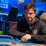 Ein Gruppenfoto von drei Pokerspielern, die an einem Turnier teilnehmen. Die Spieler sitzen an einem Pokertisch und konzentrieren sich auf ihre Karten.